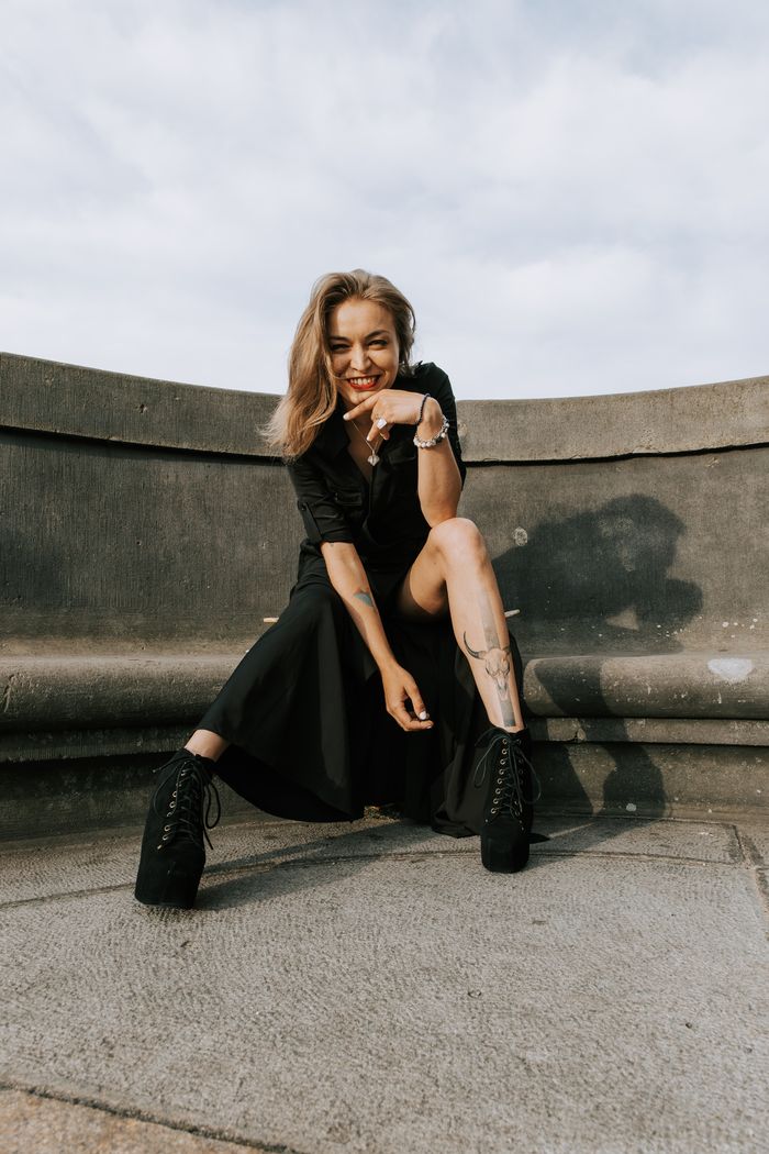 Portrait of Arnika Aluri in a black dress on a Berlin rooftop