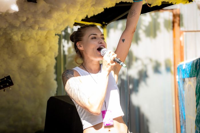 Arnika Aluri singing on stage